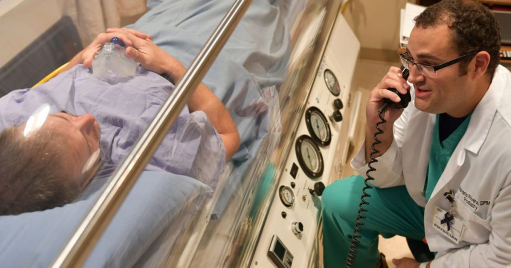 Photo of Hyperbaric Oxygen chamber and Dr. Rivera