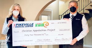 Picture of Donovan Blackburn and the President of Childers Oil holding a $42,000 check for tornado relief